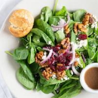 Spinach Salad · Spinach, feta cheese, dried cranberries,
candied walnuts, onion & balsamic vinaigrette dress...
