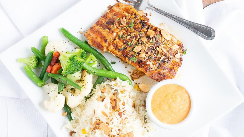 Almond Crusted Salmon · An eight-ounce salmon filet with lobster sauce. Served with steamed vegetables & your choice of rice or potato wedges.
