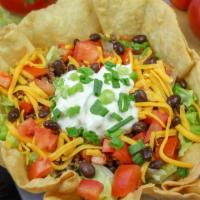 Taco Salad · Seasoned ground beef, tomatoes, onions, cheddar cheese, sour cream, black beans & lettuce in...