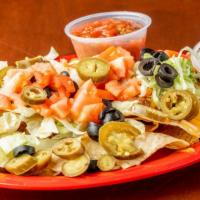 Nacho Supreme · White corn tortilla chips piled high with homemade chili, melted cheddar jack cheese, lettuc...