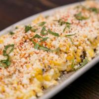 Elote · Roasted corn on the cob, mayo, cotija, epazote, dry pepper dust.