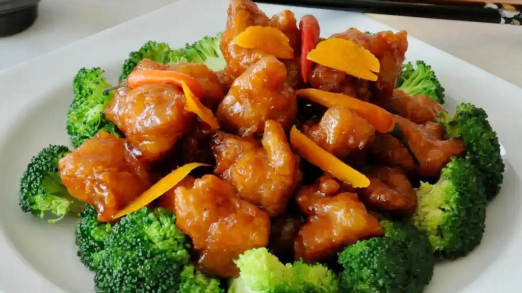 Orange Chicken · Hot, breaded chicken in golden orange sauce flavor and served with steamed broccoli. Hot and spicy.