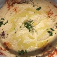 Hummus · A blend of chick peas, tahini sauce, garlic, and lemon juice. Served with pita bread.