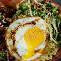 Korean Steak Bibimbap · gochujang grilled steak, served over bed of saffron rice, topped with cabbage slaw, sunny si...
