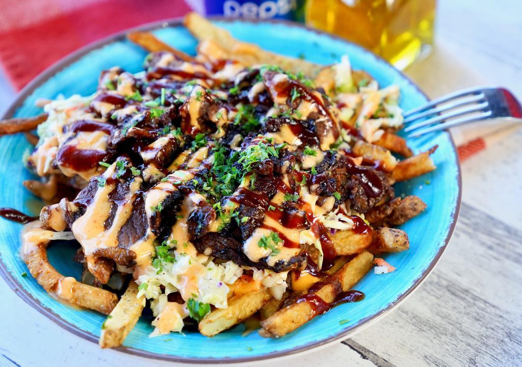 Loaded Brisket Fries · fresh cut fries, topped with 5oz smoked brisket, topped with our house made coleslaw, Korean bbq, bambam sauce.