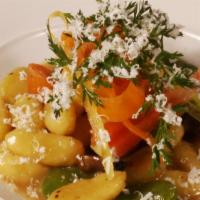 Ricotta Gnocchi · Fava beans, roasted baby carrots, and forest mushrooms.