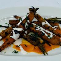 Charred Carrots · BBQ spiced grilled baby carrots, carrot honey, and Alabama white sauce.