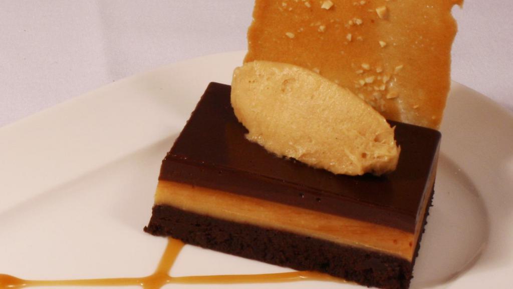 Torte · Flourless chocolate cake, chocolate ganache, peanut butter mousse, and vanilla tuile.