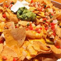 Brewhouse Nachos · Fresh tortilla chips covered wth melted cheeses, diced tomatoes and onions. Topped with sour...