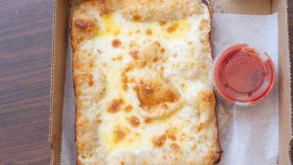 Cheese Bread · Cheesy bread with mozzarella cheese smothered with Parmesan cheese and butter garlic pizza sauce on the side