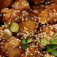 Sesame Chicken · Deep fried crispy chicken coated with a sweet and savory sauce, finished with roasted sesame...