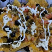 Chicken Nachos · Homemade tortilla chips topped with your choice of pull pork or grilled chicken, nacho chees...