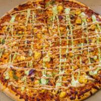 Chicken Tikka Pizza · A pizza loaded with tikka masala, mozzarella, chicken, onions, green peppers, moti sauce, ci...