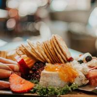 Charcuterie Board · Variety of seasonal meats cheeses spreads dried fruits and crackers.