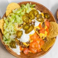 Nachos Supreme · Cheese, ground beef, nachos peppers, sour cream, lettuce, and tomato.