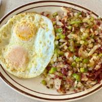 Corned Beef Hash · Side of Corned Beef Hash topped with onions and green peppers.