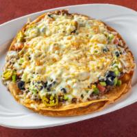 Mexican Pizza · Flour tortilla deep fried with layers of beans, meat, muenster cheese, onions, tomatoes, bla...
