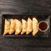 Crispy Chicken Dumplings · Six fried to perfection chicken dumplings paired with our spicy yuzu sauce.