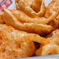 Pork Rinds · Fresh cracklings, made to order and covered in out signature seasoning.