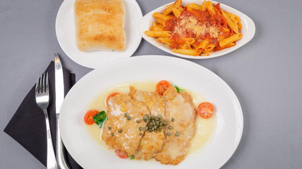 Veal Francese · Egg battered veal sautéed in lemon butter with a white wine sauce served over spinach with cherry tomatoes & capers served with a side of penne pasta with marinara.