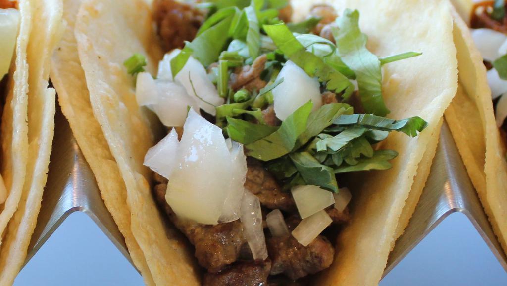 Street Taco · Corn tortillas, meat, cilantro, onion, lime, salsas.