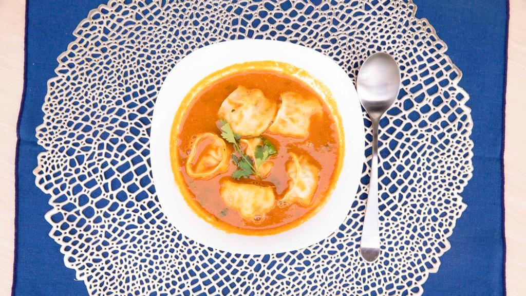Chicken Jhol Momo · Chicken momo served with johl achar. (tomato-based soup)