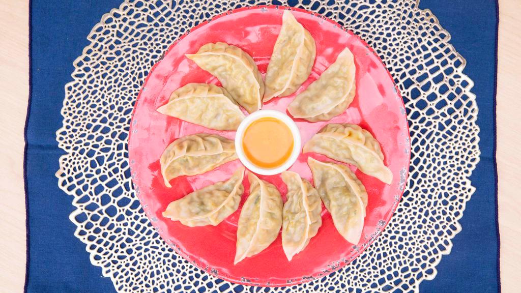 Vegetable Momo · Vegan. dumpling filled with soybean, cabbage, mashed potatoes, spices, onion, cilantro, ginger, and garlic