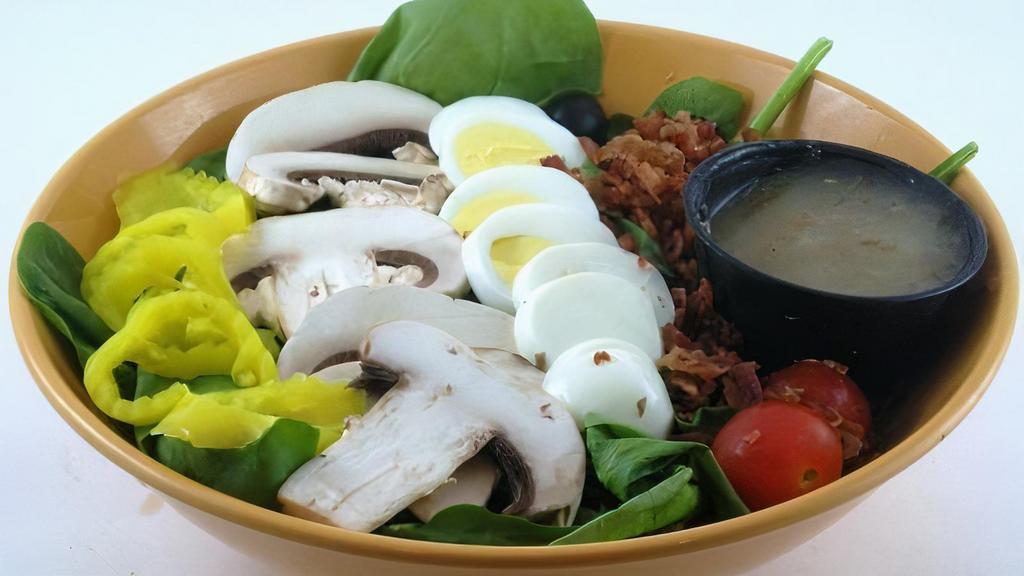 Spinach Salad · A blend of spinach, chopped egg, bacon, sliced mushrooms, cherry tomatoes, black olives, and banana pepper rings. Served with choice of dressing.