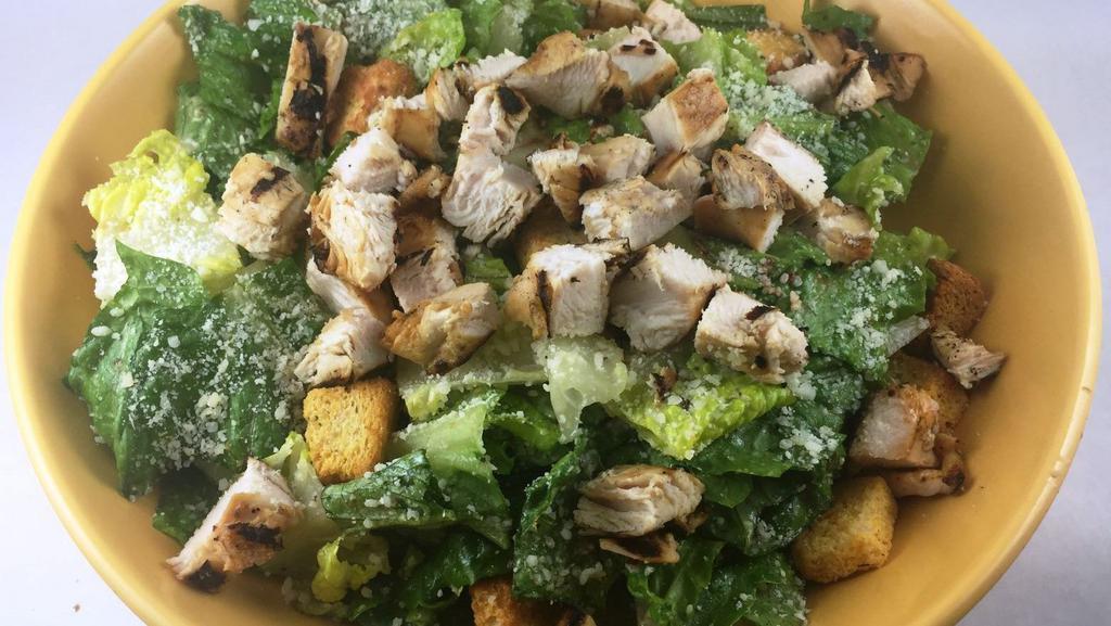 Chicken Caesar Salad · Fresh romaine lettuce tossed with our Caesar dressing and topped with Parmesan cheese and croutons and a grilled chicken breast. Dinner-sized portion!