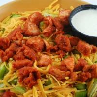 Buffalo Chicken Salad · Spicy. Crispy chicken tenders tossed in our hot sauce, cheddar cheese, diced tomatoes, and c...