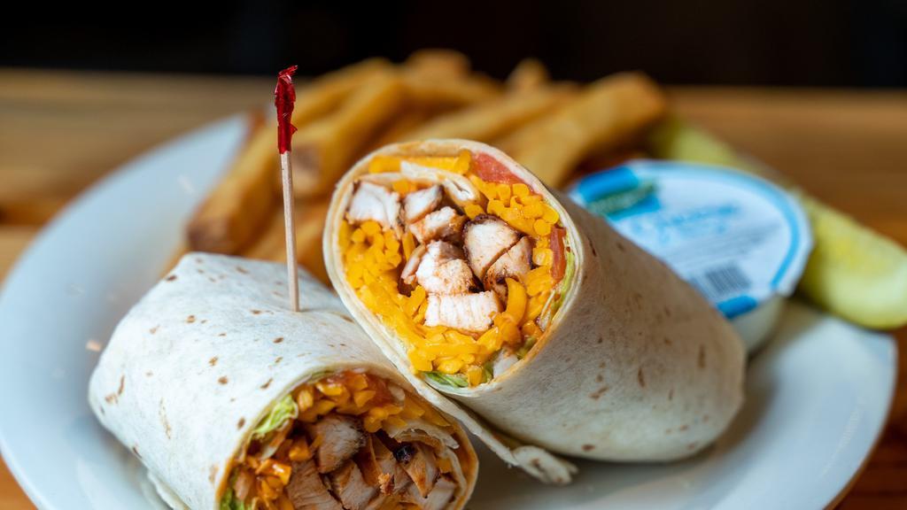 Buffalo Chicken Wrap · Spicy. Tender slices of chicken breast basted in our hot sauce and rolled up in a soft tortilla with lettuce, tomato, cheddar cheese and a side of blue cheese for dipping.