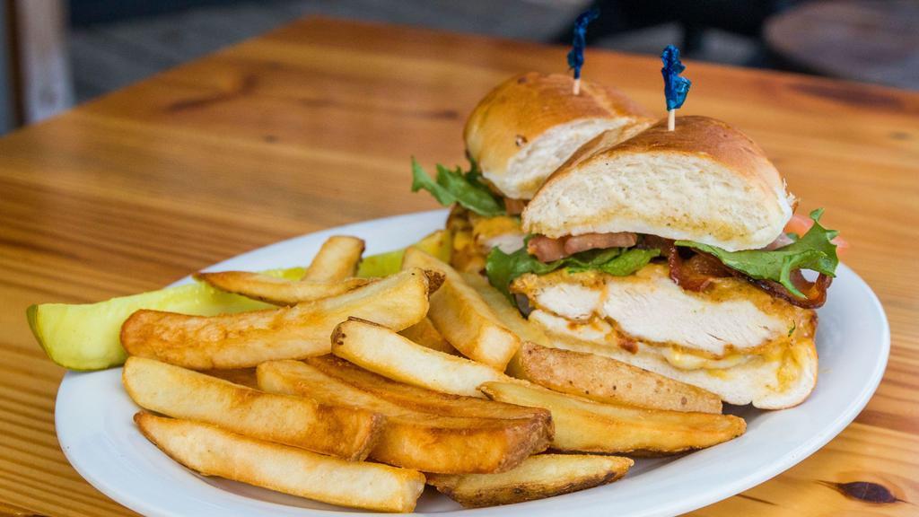 Bo-Man'S Honey Club · Breaded chicken breast tossed in our own honey mustard sauce then topped with mozzarella cheese, applewood bacon, lettuce, and tomato. Served on garlic bread.