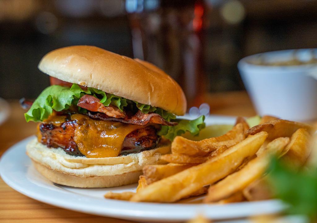 Bbq Chicken Club · A grilled chicken breast basted in our award winning BBQ sauce, topped with cheddar cheese, applewood bacon, lettuce, and tomato. Served on a deluxe roll.