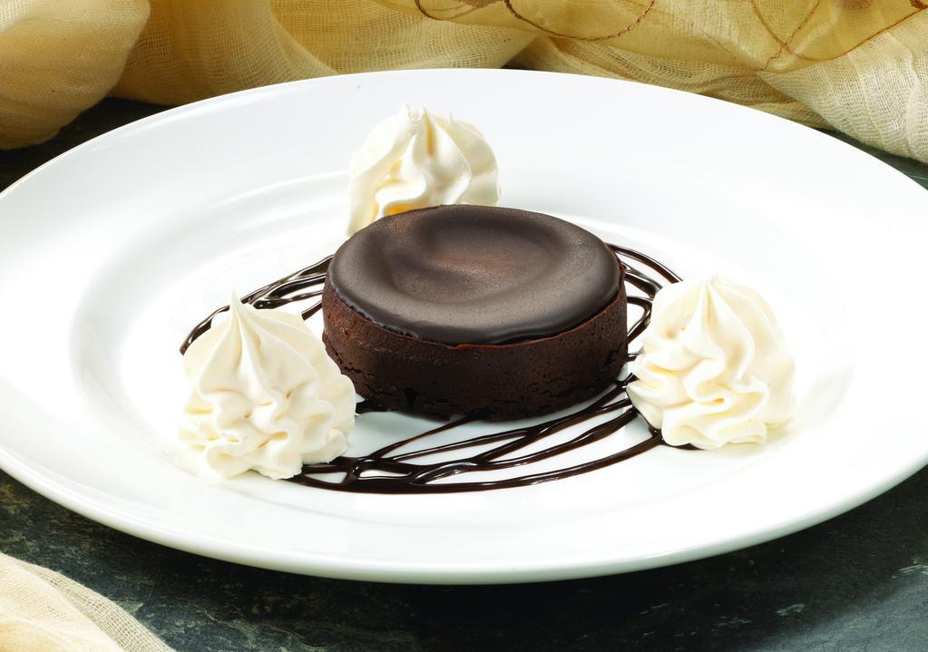 Chocolate Flourless Cake · A rich and decadent flourless cake, topped with chocolate ganache. Served atop chocolate sauce and garnished with whipped cream.