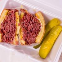Corned Beef Sandwich · 1/2 lb. Wigleys Corned beef with mustard and Swiss cheese with a Deli pickle on Onion roll o...