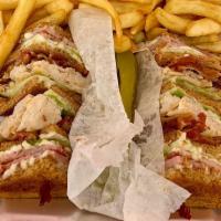 Triple Decker Club Sandwich · Triple Decker with layers of smoked turkey breast, crisp bacon, ham, lettuce, tomatoes and m...