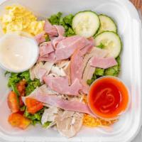 Chef Salad · Chopped lettuce, turkey, ham, shredded cheese, tomatoes, and scoop of egg salad.
