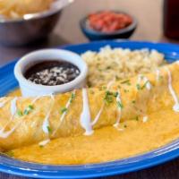 Enchilada De Monterrey · Pulled chicken and Monterrey jack rolled burrito-style in a flour tortilla and covered with ...