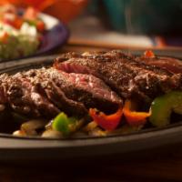 Steak Fajitas · Grilled Steak served sizzling with onions, green peppers, warm flour tortillas, cheese, lett...