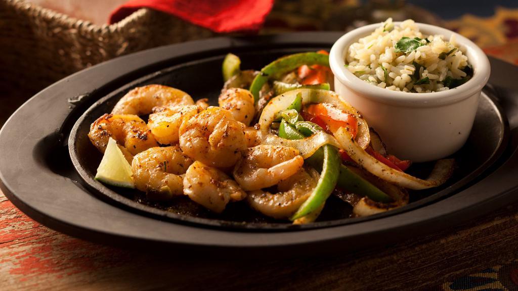 Shrimp Fajitas · Broiled Chipotle-basted Shrimp served sizzling with onions, green peppers, warm flour tortillas, cheese, lettuce, sour cream and Pico de Gallo.