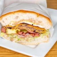 Torta Cubana · Mexican sandwich filled with beef or chicken, ham, sausage, egg, lettuce, tomato, avocado, j...