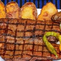 Grilled Skirt Steak · Grilled skirt steak accompanied with cebollitas, chile toreado (fried jalapeno), served with...