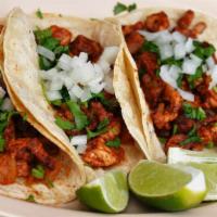 Al Pastor Taco · All tacos are served on fresh soft corn tortillas, garnished with fresh chopped cilantro, on...