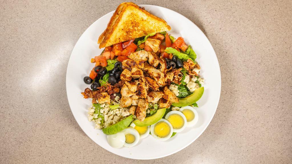 Cobb Salad · Grilled chicken, avocado, hard boiled legs, bacon, black olives tomato & bleu cheese crumbles on romaine lettuce.