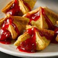 Cheesecake Rangoons · Cheesecake-filled rangoons served with choice of topping.