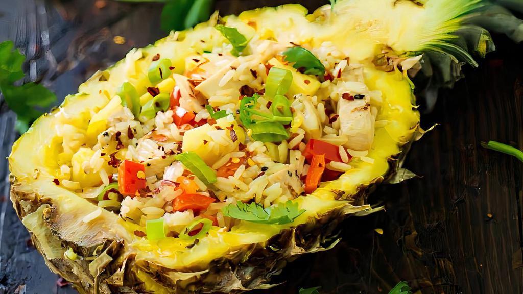 Tropical Fried Rice · A rich blend of fresh pineapple, raisins, cashews, and onions combined with chicken, shrimp, and rice. Served in a fresh pineapple bowl.