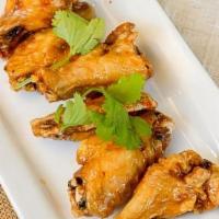 Chicken Wings · Broasted chicken wings served with sweet Asian zing sauce (6 pieces).