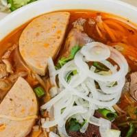 Hue(Whey) Spicy Noodle Soup · Spicy lemongrass beef broth flavored with shrimp paste. Served with brisket, pork feet, cong...