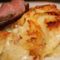 Scalloped Potatoes · Chopped potatoes seasoned cooked with onions green and mixed peppers.