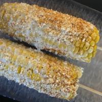 Corn On The Cobb · Grilled buttered corn lightly topped with parmesan cheese.